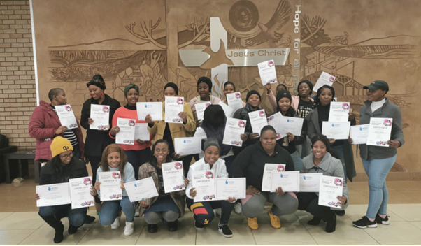 Group of graduates holding certificates