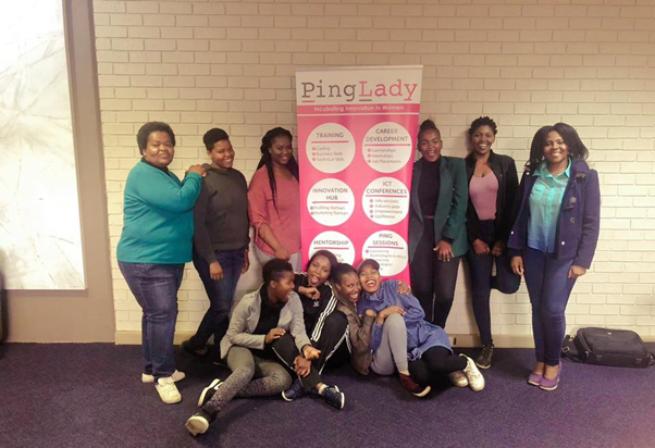 Ladies posing with pullup banner