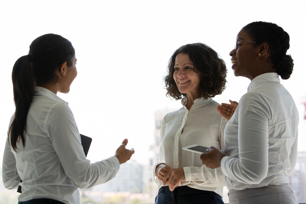 Team of happy female colleagues chatting